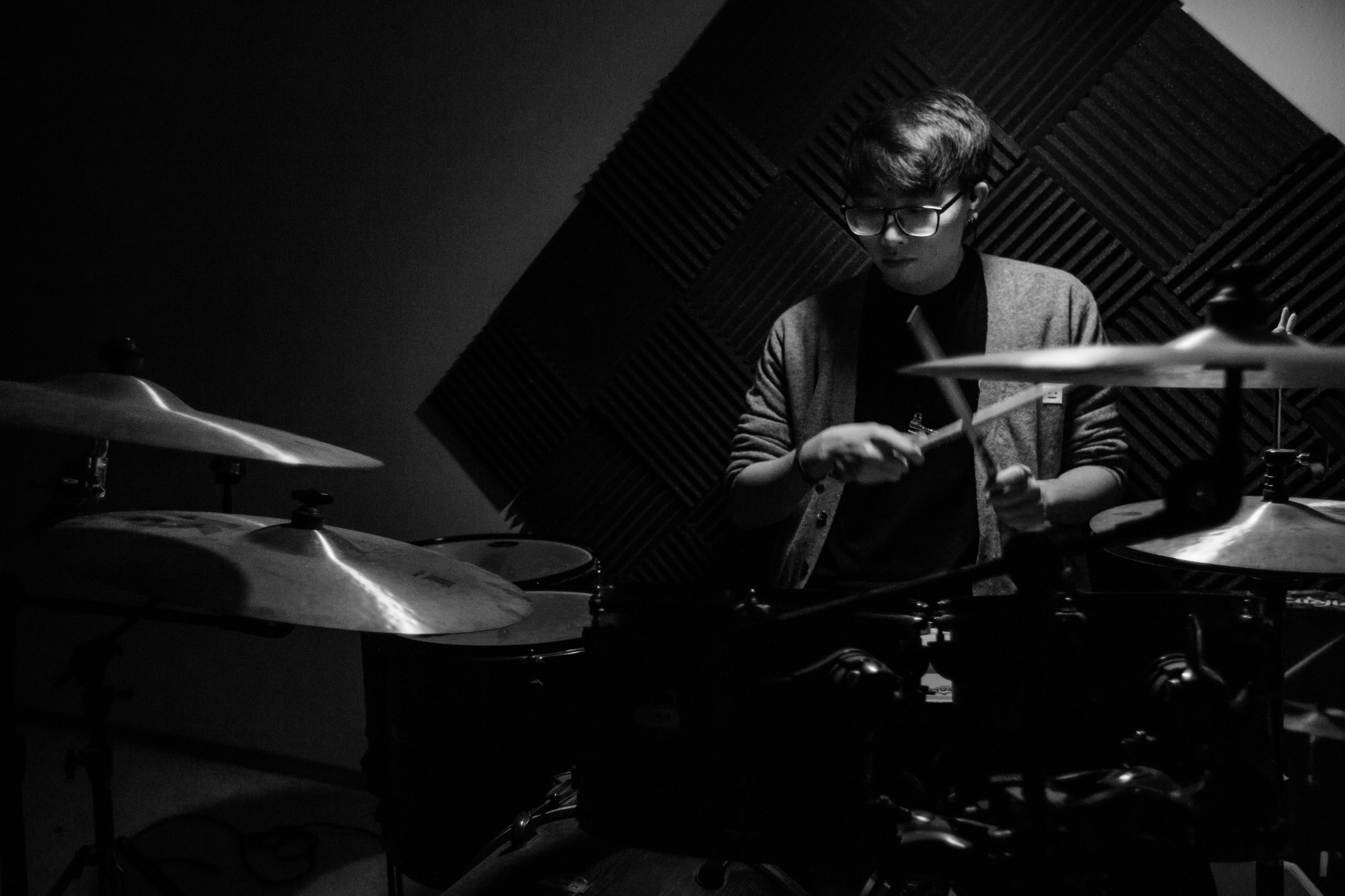 Black-and-white portrait of a drummer performing