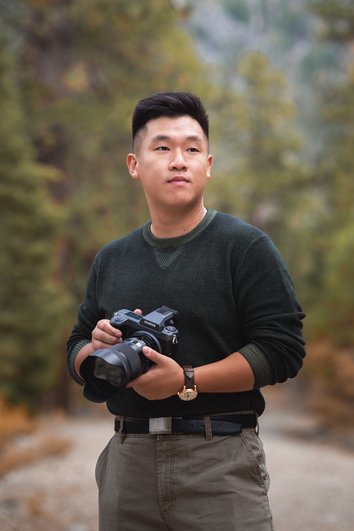 Quang, the photographer behind ShutterQueue, holding his camera outdoors